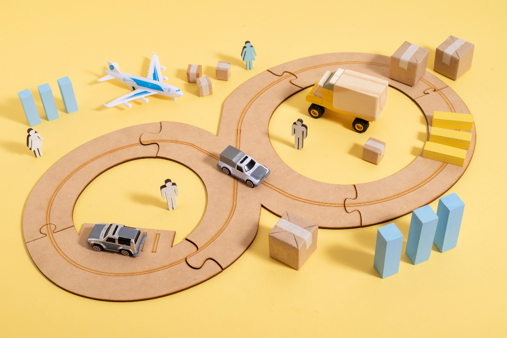 A miniature train track with various cars and trucks, representing the idea of 'Navigating Transport Costs'.